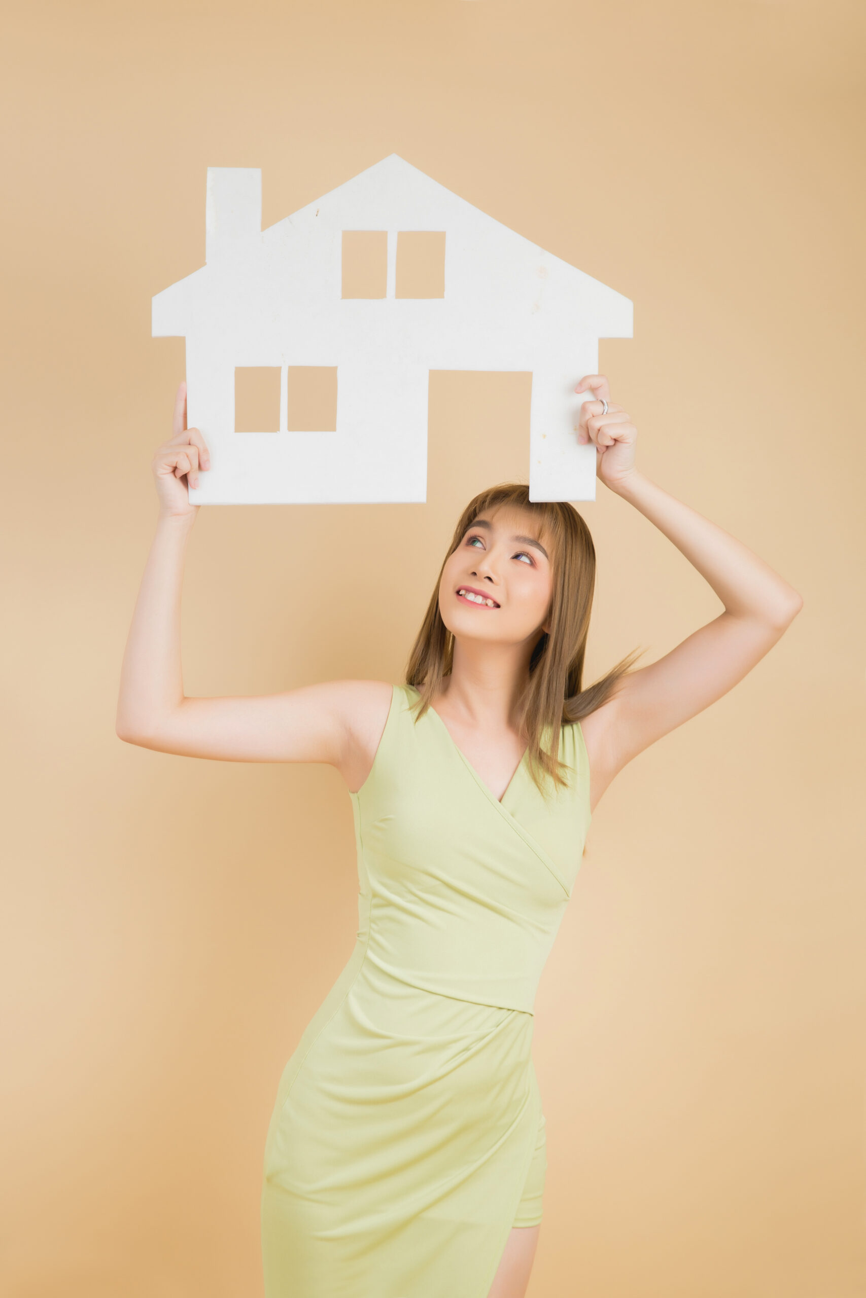 Excited woman holding paper home